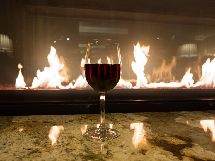 Wine and fireplace in lobby at Hotel Monaco